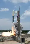 A Delta II rocket ignites its engines, including 9 GEM 46 solid rockets.