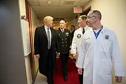 President Donald J. Trump talks with, from left to right, with Capt. Mark Kobelja, Director of Walter Reed National Military Medical Center; Dr. Ronny Jackson, Physician to the President; and Dr. James Jones, physical to the President and medical director of the Medical Evaluation and Treatment Unit, Friday January 12, 2018, in Bethesda, MD, following the President's annual physical at the medical facility.