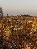 Abandoned farm. In the distance you can see the Belarusian farm with a water tower