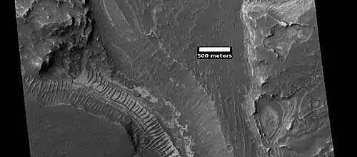 Layers on floor of Noctus Labyrinthus, as seen by HiRISE under HiWish program. Layers probably contain a variety of minerals that were formed with groundwater.