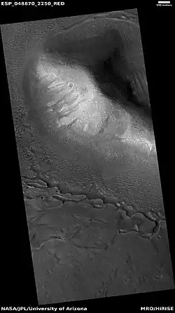 Wide view of upper plains unit eroding into hollows, as seen by HiRISE under HiWish program Parts of this image are enlarged in following images.