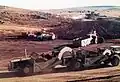 Earth moving equipment dumping fill from the borrow pits for the wall of Sterkfontein Dam. August 1972.