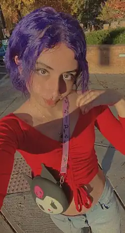 A selfie of late Eden Knight, in purple hair and in her crop top and jeans
