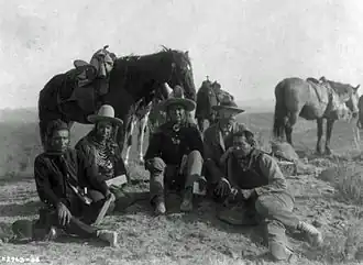 Three of Custer's scouts accompanying Edward Curtis on his investigative tour of the battlefield, c. 1907. Left to right: Goes Ahead, Hairy Moccasin, White Man Runs Him, Curtis and Alexander B. Upshaw (Curtis's assistant and Crow interpreter)