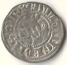 A faded silver coin with an indistinct king's head in the centre with long hair, surrounded by faded writing.