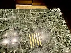 Elevators of Millennium Hilton Hotel — One United Nations Plaza carrying same motif of dark green-marbled floors and inlaid brass, as in lobby.