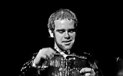 Black-and-white photograph of Elton John performing live in 1972.