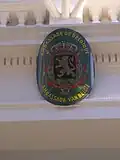 Plaque above the entrance showing the Coat of arms of Belgium, lesser version
