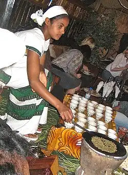 Image 33An Ethiopian woman preparing Ethiopian coffee at a traditional ceremony. She roasts, crushes, and brews the coffee on the spot. (from Culture of Africa)