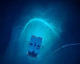 "Image of remotely operated vehicle Deep Discoverer exploring a spectacular arcuate, headwall scarp measuring 20 meters (66 feet) across, seen in the carbonate Juana Diaz Formation, Guayanilla Canyon, to the south of Puerto Rico" (NOAA)