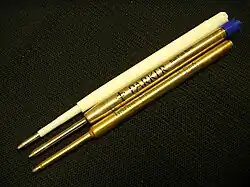 Three stacked pen refills with similar fittings for comparison