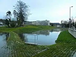 The same pond, full of the water it is detaining, during a flood. Once the peak of the flood has passed, it will slowly drain again.