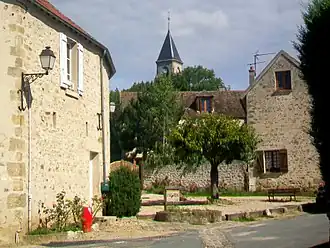 The fountain in Frémainville, with the church in the background