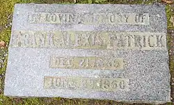 Flat grey granite stone inscribed with his name, birth and death years