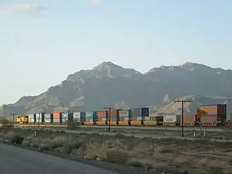 A train of well cars in Arizona carrying double-stacked containers