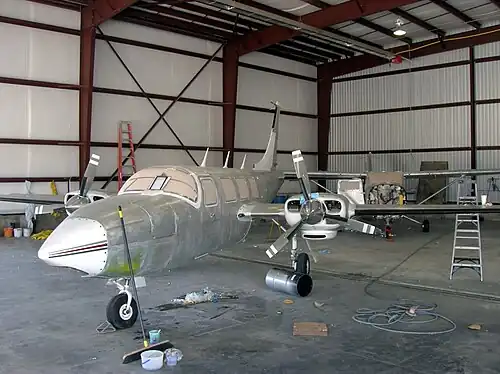 An aircraft getting stripped of paint in preparation for maintenance at Colorado Air and Space Port