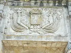 Pediment: Coat of arms with three defaced fleurs-de-lis. Ornaments: royal crown, standards, and Legion of Honour symbols