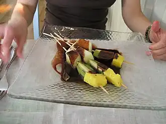 Fruit brochette with warm chocolate