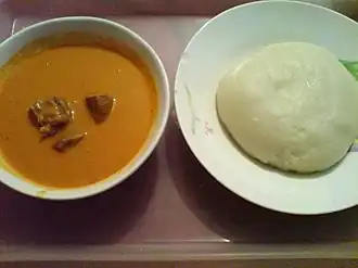 Image 43Fufu (right) is a staple meal in West Africa and Central Africa. It is usually served with some peanut soup. (from Culture of Africa)