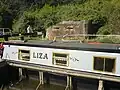 Canal boat next to pill box at Garston Lock