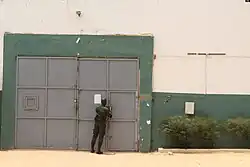 A guard shuts a prison door.