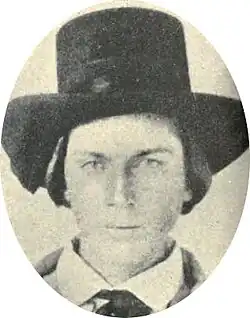 19th-century portrait photograph of a young man in a suit, tie, and top hat