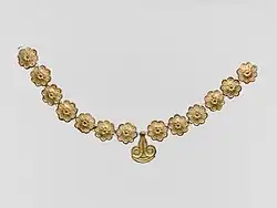 Necklace; 1400-1050 BC; gilded terracotta; diameter of the rosettes: 2.7 cm, with variations of circa 0.1 cm, length of the pendant 3.7 cm; Metropolitan Museum of Art