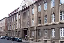 A gray building in a street.
