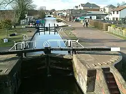 A lock and upstream tract to a white humpback bridge at Apsley, Hertfordshire