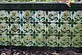 Tiles on the side of a grave with floral designs on them