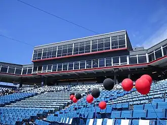 A view of the concourse behind home plate. Overlooking the field are sky boxes and the press box on the third floor and the fourth floor stadium restaurant, all of which are fronted by glass windows.