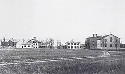 Groveland Shaker Village, New York., 1890s. The photograph includes an 1842 meetinghouse (right), shops, and a four-story, late 1850s brick East Family building. New York State Museum, Albany.