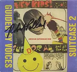 A collage with comic strip art, black-and-white photos, a jack-in-the-box, and a smiley face wearing a hat