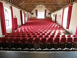 The original 15th-century wooden roof is visible inside the auditorium that once hosted Shakespeare