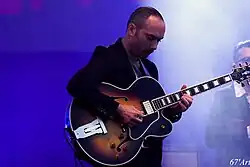 Gresset performing on stage as part of Thomas Dutronc's band, 2015