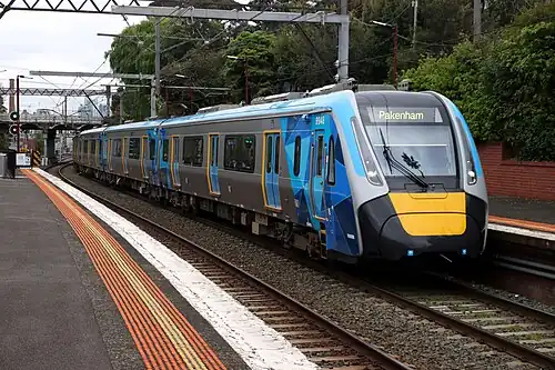 A high capacity metro train at a station in Melbourne