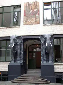 A portal with the front of two elephants beside the door.
