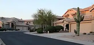 Two-story tract homes with beige roofs in a desert setting