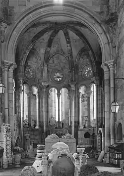 Main altar of São João do Alporão Church with a Romanesque ambulatory below a rib vault.