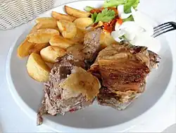 Roast lamb from a roasting spit, served with potato and onion in Istria County, part of Croatian cuisine