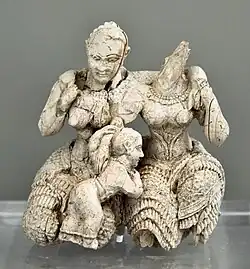 Two women and a child; 1400-1300 BC; ivory; height: 7.8 cm; National Archaeological Museum (Athens)[14]