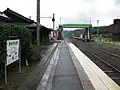 A view of the platforms and tracks. the sidings can be seen behind the footbridge to the left.