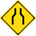 Road narrows on both sides
