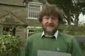 Jim Ridge, in front of his cottage on 3 September 1993, reading the letter he wrote to Time Team. Ridge died on 21 January 2003[6][7]
