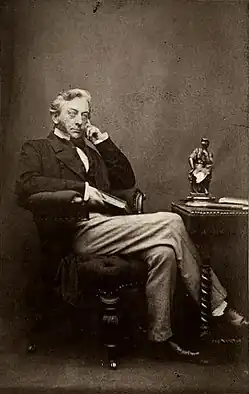 A portrait of Willis, sitting in a chair