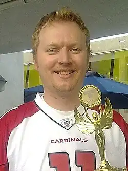 A man holding a trophy