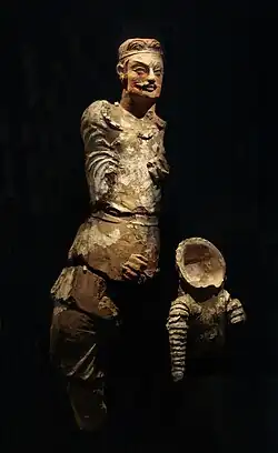Yuezhi Prince from Khalchayan. At his feet, the trophy of a Saka cataphract armour with neck-guard. 1st century BCE. Museum of Arts of Uzbekistan, nb 40.[10][11]