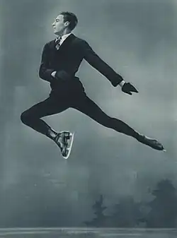 Male figure skater performing a jump