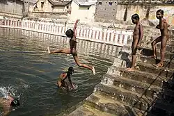 Boys skinny dipping in a sacred tank in Tiruvannamalai, India (2006)