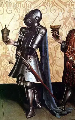 Knight wearing a great bascinet. The strap fixing the helmet to the breastplate is visible as is the impossibility of rotating the helmet. German painting by Konrad Witz, 1435